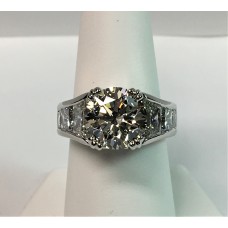 Platinum and diamond ring with round brilliant center and trapezoid/princess side diamonds